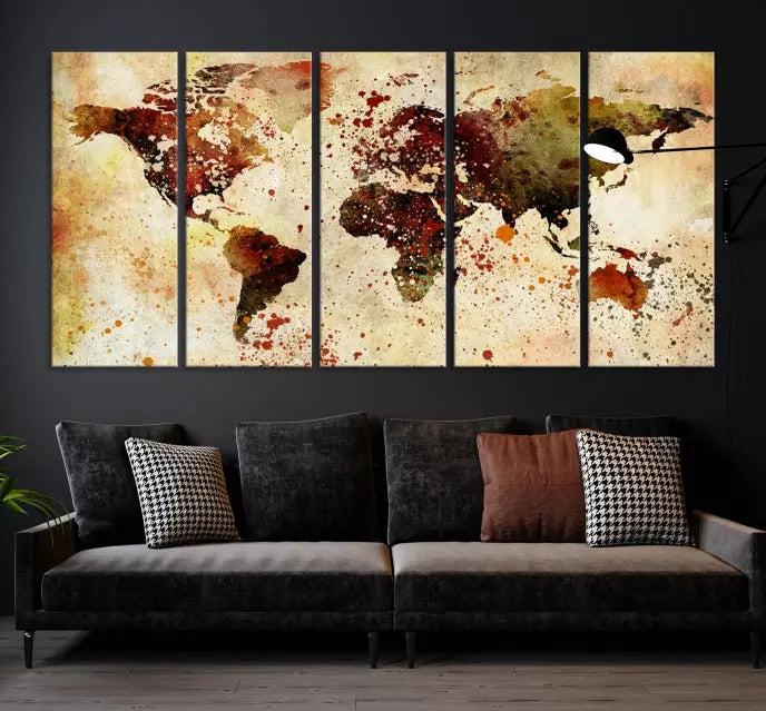 The World Map Wall Art Canvas Print, gallery-wrapped on museum-quality canvas adorned with watercolor splatters, enhances a modern living room decor. This artwork features a UV-protective coating to maintain its vibrant colors and elegant appearance over time.