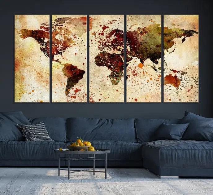 The World Map Wall Art Canvas Print, gallery-wrapped on museum-quality canvas adorned with watercolor splatters, enhances a modern living room decor. This artwork features a UV-protective coating to maintain its vibrant colors and elegant appearance over time.