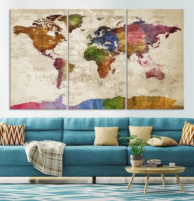 The World Map Wall Art Canvas Print, featuring a vibrant triptych design on museum-quality canvases, decorates the wall. The gallery-wrapped artwork is treated with a UV-protective coating to ensure its colors remain vivid over time.