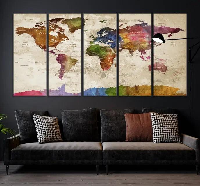 The World Map Wall Art Canvas Print, featuring a vibrant triptych design on museum-quality canvases, decorates the wall. The gallery-wrapped artwork is treated with a UV-protective coating to ensure its colors remain vivid over time.