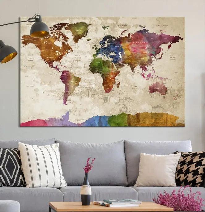 The World Map Wall Art Canvas Print, featuring a vibrant triptych design on museum-quality canvases, decorates the wall. The gallery-wrapped artwork is treated with a UV-protective coating to ensure its colors remain vivid over time.