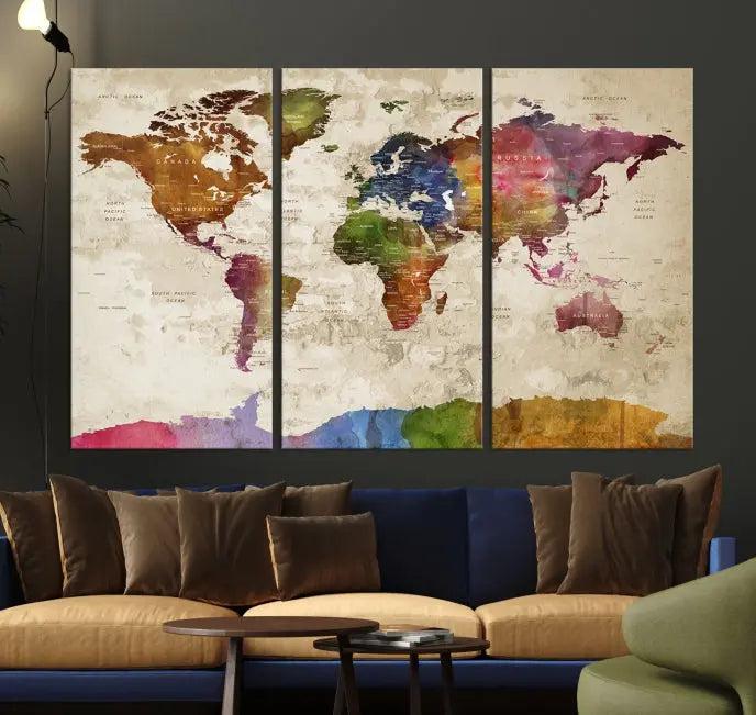 The World Map Wall Art Canvas Print, featuring a vibrant triptych design on museum-quality canvases, decorates the wall. The gallery-wrapped artwork is treated with a UV-protective coating to ensure its colors remain vivid over time.