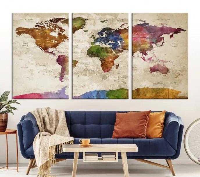 The World Map Wall Art Canvas Print, featuring a vibrant triptych design on museum-quality canvases, decorates the wall. The gallery-wrapped artwork is treated with a UV-protective coating to ensure its colors remain vivid over time.