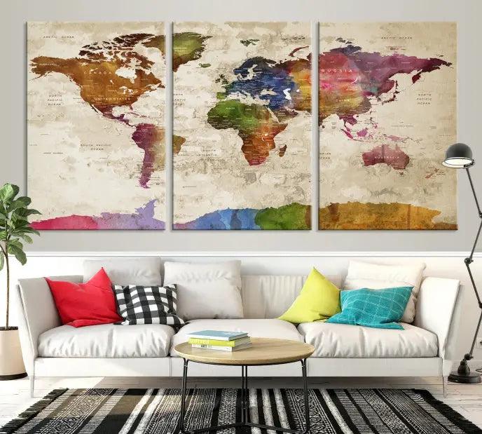 The World Map Wall Art Canvas Print, featuring a vibrant triptych design on museum-quality canvases, decorates the wall. The gallery-wrapped artwork is treated with a UV-protective coating to ensure its colors remain vivid over time.