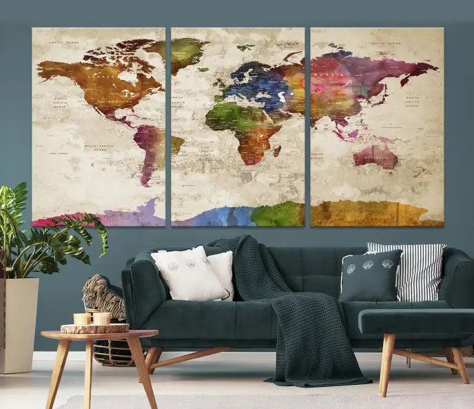 The World Map Wall Art Canvas Print, featuring a vibrant triptych design on museum-quality canvases, decorates the wall. The gallery-wrapped artwork is treated with a UV-protective coating to ensure its colors remain vivid over time.