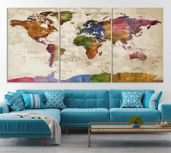 The World Map Wall Art Canvas Print, featuring a vibrant triptych design on museum-quality canvases, decorates the wall. The gallery-wrapped artwork is treated with a UV-protective coating to ensure its colors remain vivid over time.