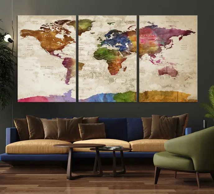 The World Map Wall Art Canvas Print, featuring a vibrant triptych design on museum-quality canvases, decorates the wall. The gallery-wrapped artwork is treated with a UV-protective coating to ensure its colors remain vivid over time.