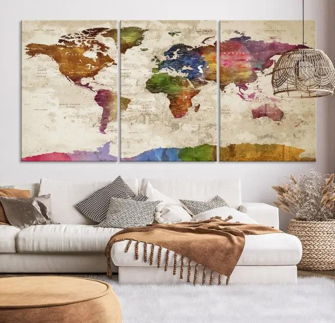 The World Map Wall Art Canvas Print, featuring a vibrant triptych design on museum-quality canvases, decorates the wall. The gallery-wrapped artwork is treated with a UV-protective coating to ensure its colors remain vivid over time.