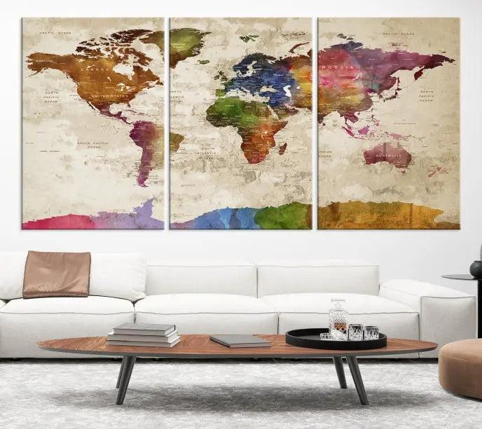 The World Map Wall Art Canvas Print, featuring a vibrant triptych design on museum-quality canvases, decorates the wall. The gallery-wrapped artwork is treated with a UV-protective coating to ensure its colors remain vivid over time.