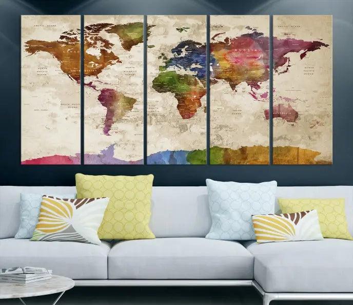 The World Map Wall Art Canvas Print, featuring a vibrant triptych design on museum-quality canvases, decorates the wall. The gallery-wrapped artwork is treated with a UV-protective coating to ensure its colors remain vivid over time.