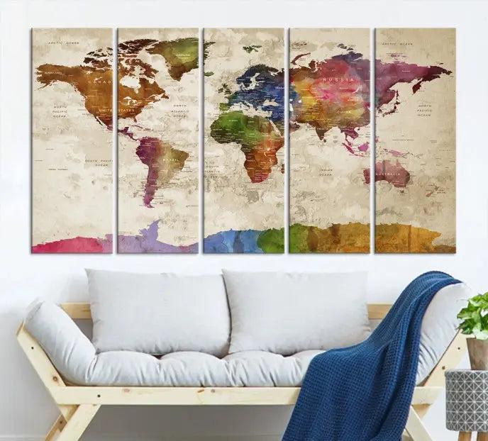 The World Map Wall Art Canvas Print, featuring a vibrant triptych design on museum-quality canvases, decorates the wall. The gallery-wrapped artwork is treated with a UV-protective coating to ensure its colors remain vivid over time.