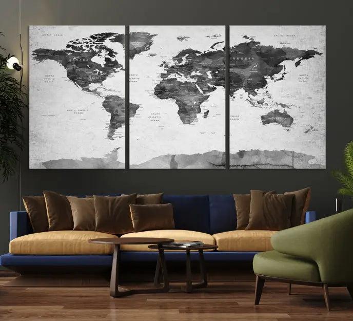 The World Map Wall Art Canvas Print features a three-panel design, printed on museum-quality canvas with a UV-protective coating, and is elegantly displayed on a dark wall.