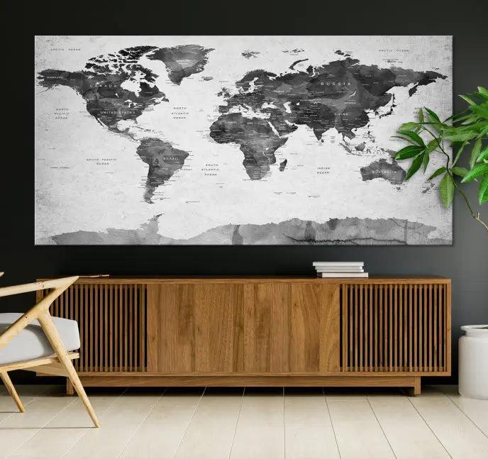 The World Map Wall Art Canvas Print features a three-panel design, printed on museum-quality canvas with a UV-protective coating, and is elegantly displayed on a dark wall.