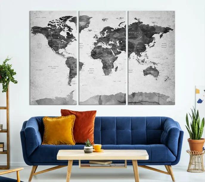 The World Map Wall Art Canvas Print features a three-panel design, printed on museum-quality canvas with a UV-protective coating, and is elegantly displayed on a dark wall.