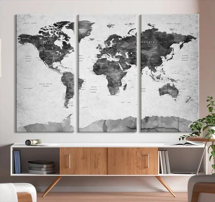 The World Map Wall Art Canvas Print features a three-panel design, printed on museum-quality canvas with a UV-protective coating, and is elegantly displayed on a dark wall.