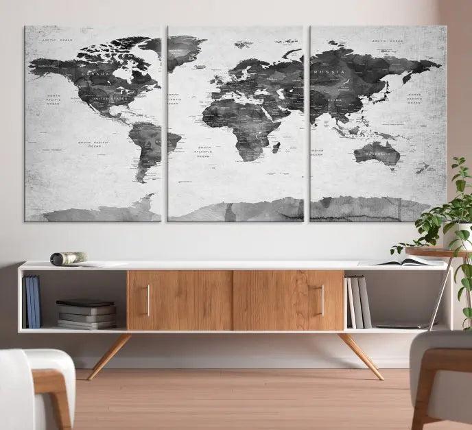 The World Map Wall Art Canvas Print features a three-panel design, printed on museum-quality canvas with a UV-protective coating, and is elegantly displayed on a dark wall.