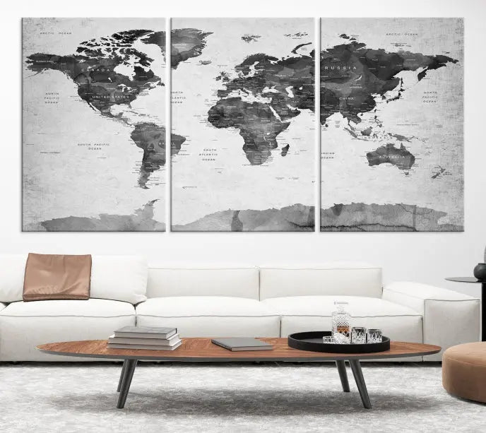 The World Map Wall Art Canvas Print features a three-panel design, printed on museum-quality canvas with a UV-protective coating, and is elegantly displayed on a dark wall.