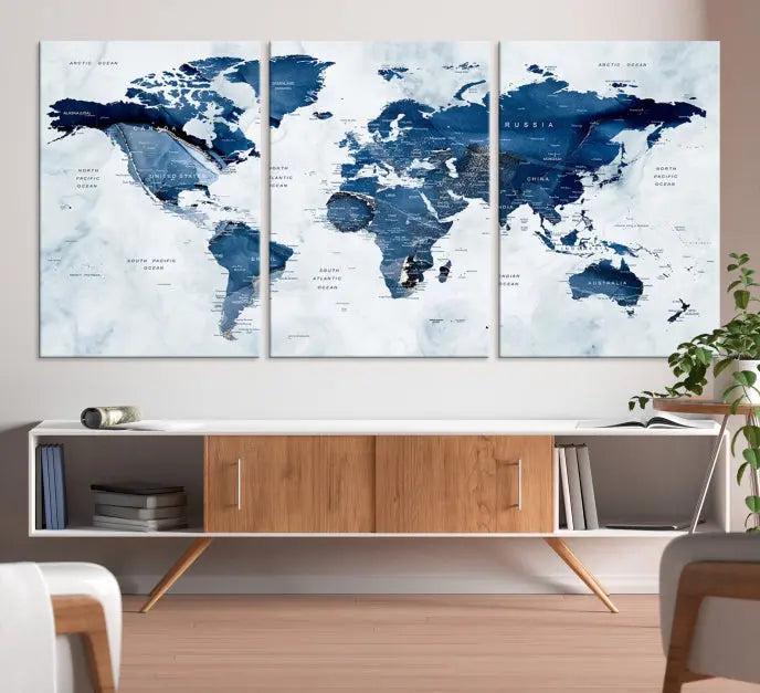 World Map Wall Art Canvas Print featuring blue continents on a textured backdrop, crafted with museum-quality polycotton and gallery-wrapped.