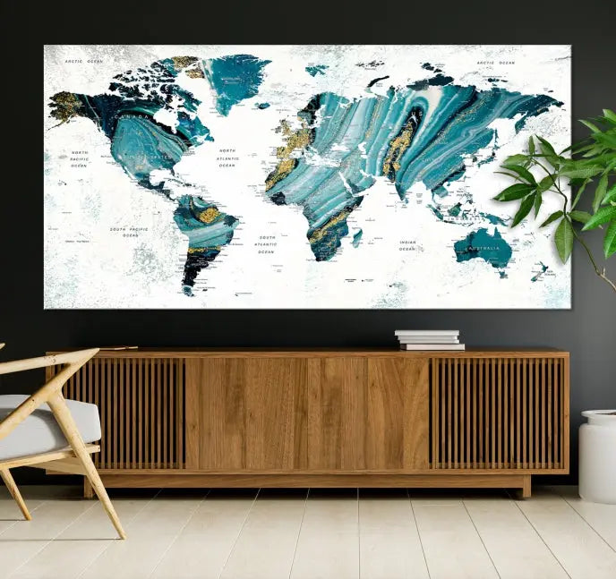 The modern living room features the World Map Wall Art Canvas Print, a three-panel abstract design on museum-quality canvases. The artwork includes a UV-protective coating and is ready to hang.