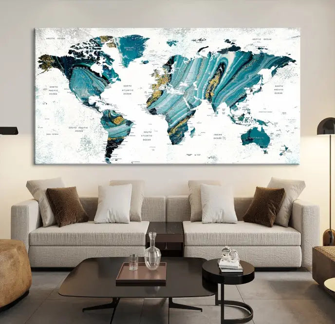 The modern living room features the World Map Wall Art Canvas Print, a three-panel abstract design on museum-quality canvases. The artwork includes a UV-protective coating and is ready to hang.