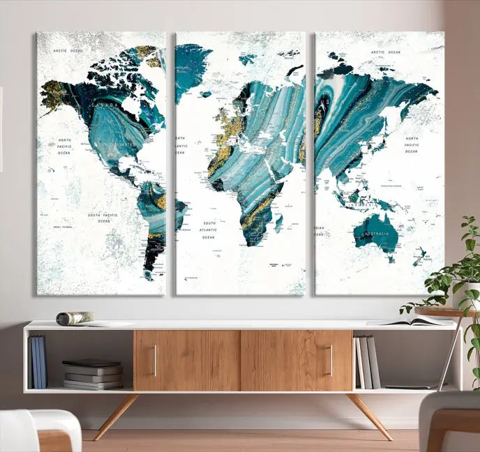 The modern living room features the World Map Wall Art Canvas Print, a three-panel abstract design on museum-quality canvases. The artwork includes a UV-protective coating and is ready to hang.