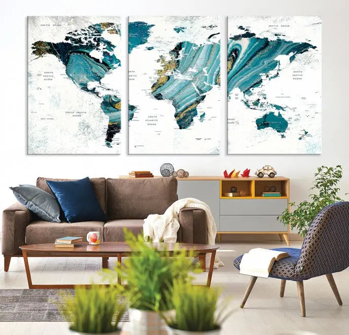 The modern living room features the World Map Wall Art Canvas Print, a three-panel abstract design on museum-quality canvases. The artwork includes a UV-protective coating and is ready to hang.