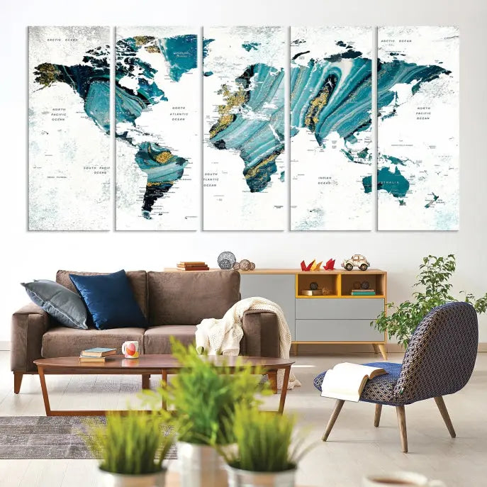 The modern living room features the World Map Wall Art Canvas Print, a three-panel abstract design on museum-quality canvases. The artwork includes a UV-protective coating and is ready to hang.