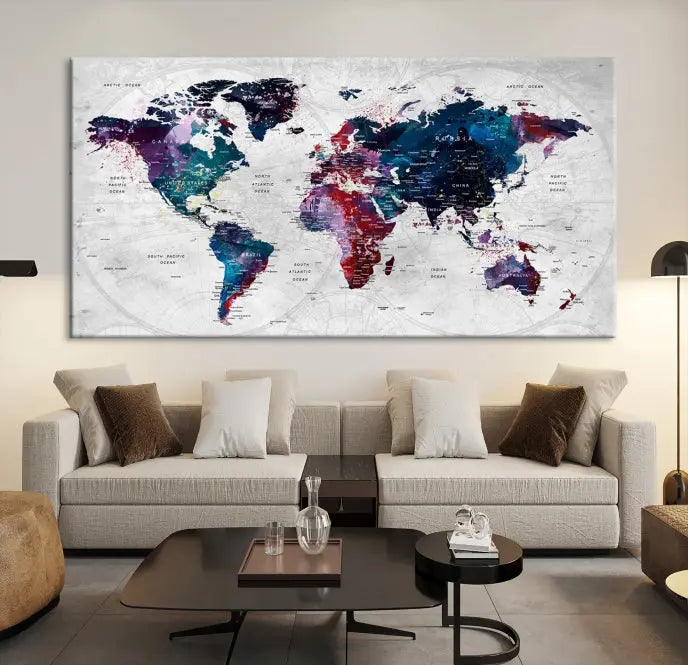 The "World Map Wall Art Watercolor Wall Art Canvas Print," a triptych featuring a vibrant world map, is gallery wrapped on museum-quality canvas and enhances the dark wall.