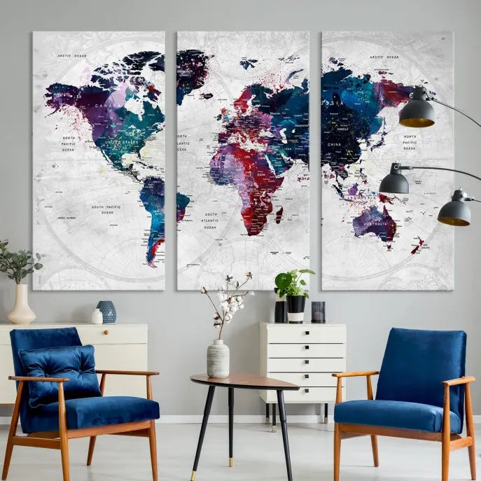 The "World Map Wall Art Watercolor Wall Art Canvas Print," a triptych featuring a vibrant world map, is gallery wrapped on museum-quality canvas and enhances the dark wall.