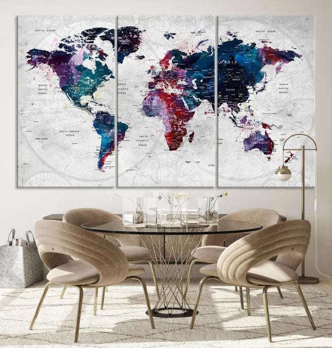 The "World Map Wall Art Watercolor Wall Art Canvas Print," a triptych featuring a vibrant world map, is gallery wrapped on museum-quality canvas and enhances the dark wall.