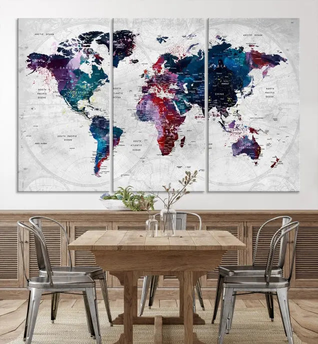 The "World Map Wall Art Watercolor Wall Art Canvas Print," a triptych featuring a vibrant world map, is gallery wrapped on museum-quality canvas and enhances the dark wall.