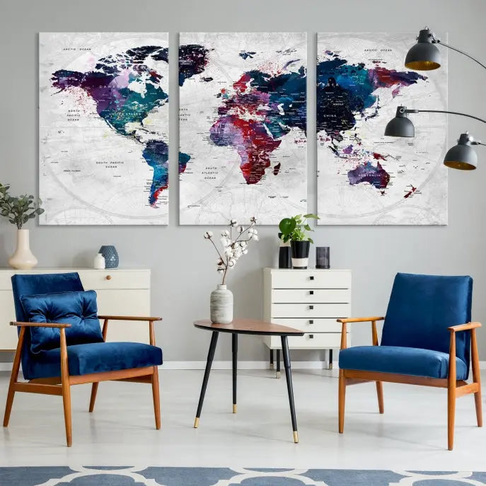 The "World Map Wall Art Watercolor Wall Art Canvas Print," a triptych featuring a vibrant world map, is gallery wrapped on museum-quality canvas and enhances the dark wall.