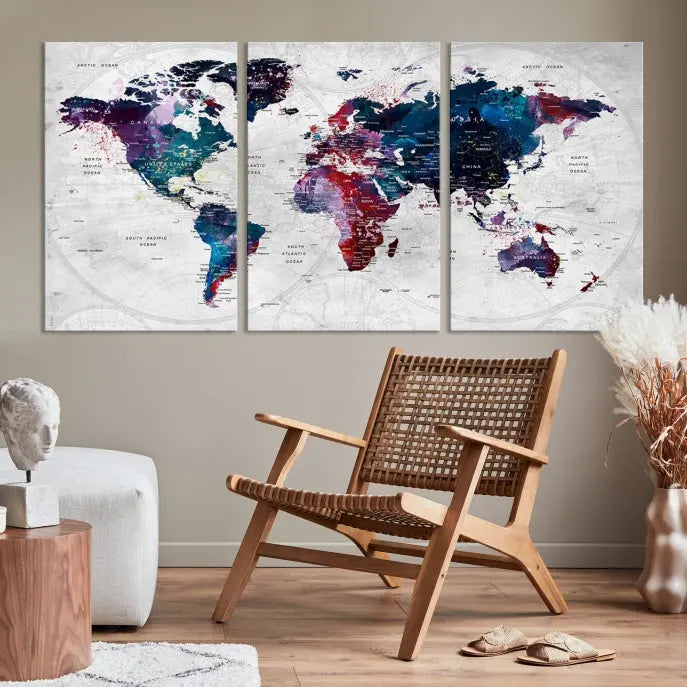 The "World Map Wall Art Watercolor Wall Art Canvas Print," a triptych featuring a vibrant world map, is gallery wrapped on museum-quality canvas and enhances the dark wall.