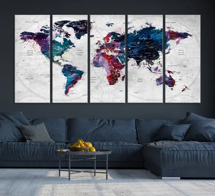 The "World Map Wall Art Watercolor Wall Art Canvas Print," a triptych featuring a vibrant world map, is gallery wrapped on museum-quality canvas and enhances the dark wall.