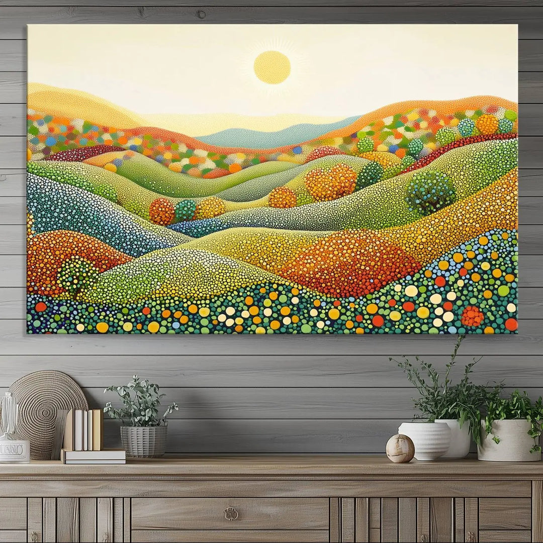 The YAYOI KUSAMA Colorful Dot Art Landscape Canvas, a framed abstract pointillism piece inspired by nature featuring vibrant rolling hills and a sun, adds gallery-quality elegance to your living space.