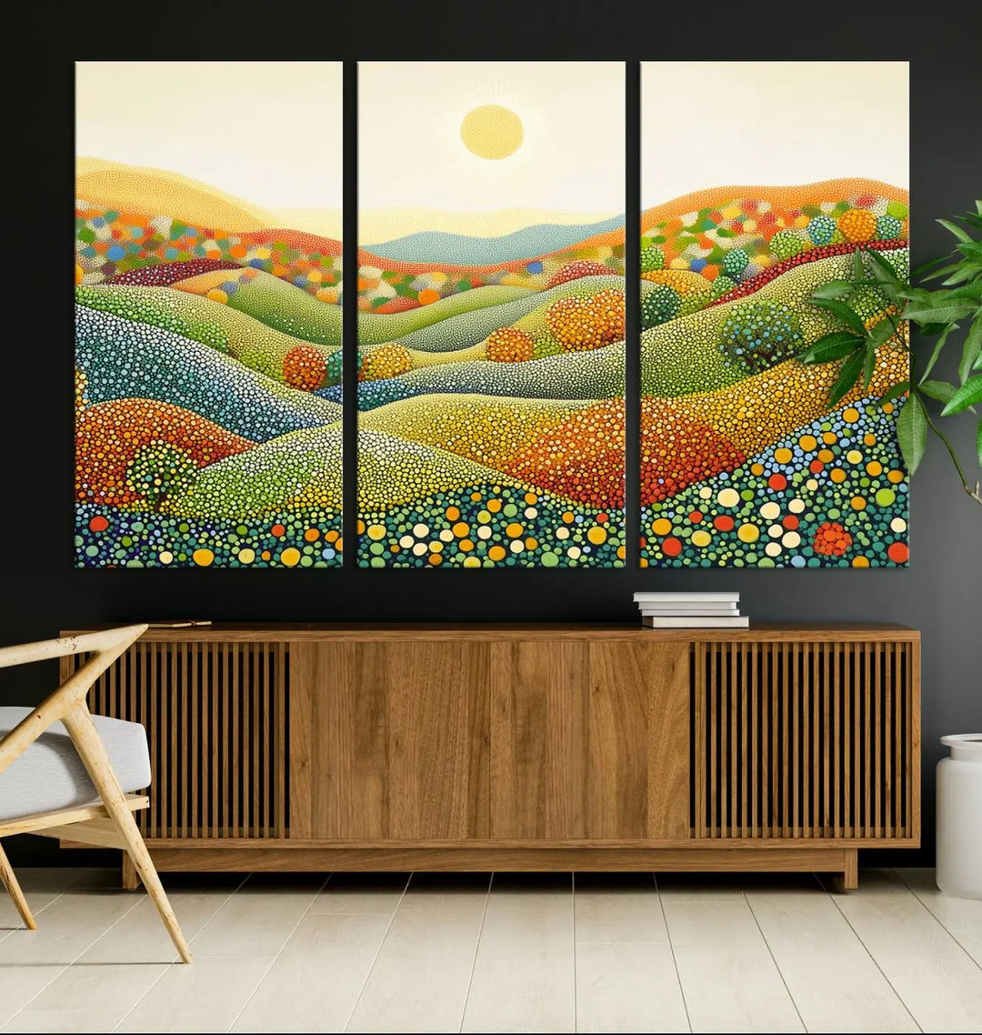 The YAYOI KUSAMA Colorful Dot Art Landscape Canvas, a framed abstract pointillism piece inspired by nature featuring vibrant rolling hills and a sun, adds gallery-quality elegance to your living space.