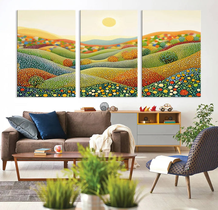 A triptych of the YAYOI KUSAMA Wall Art features a colorful dot art landscape on canvas with vibrant rolling hills and a sun, reminiscent of abstract pointillism inspired by nature.