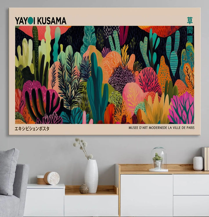 The vibrant canvas print of wall art features abstract plants, with the elegant text "Yayoi Kusama Wall Art Canvas Print" displayed on the colorful frame.