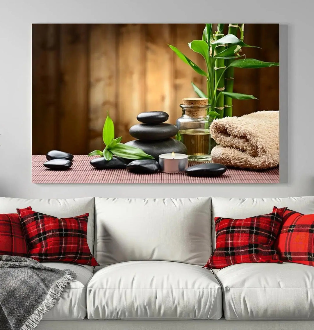 The Zen Serenity Triptych Canvas Art adorns the wall, featuring a pink lotus flower, balancing stones, towels, and bamboo.