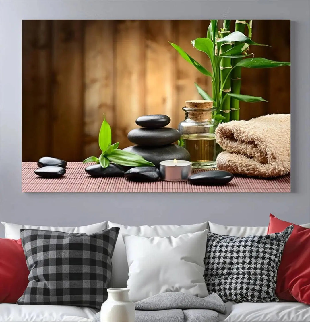 The Zen Serenity Triptych Canvas Art adorns the wall, featuring a pink lotus flower, balancing stones, towels, and bamboo.