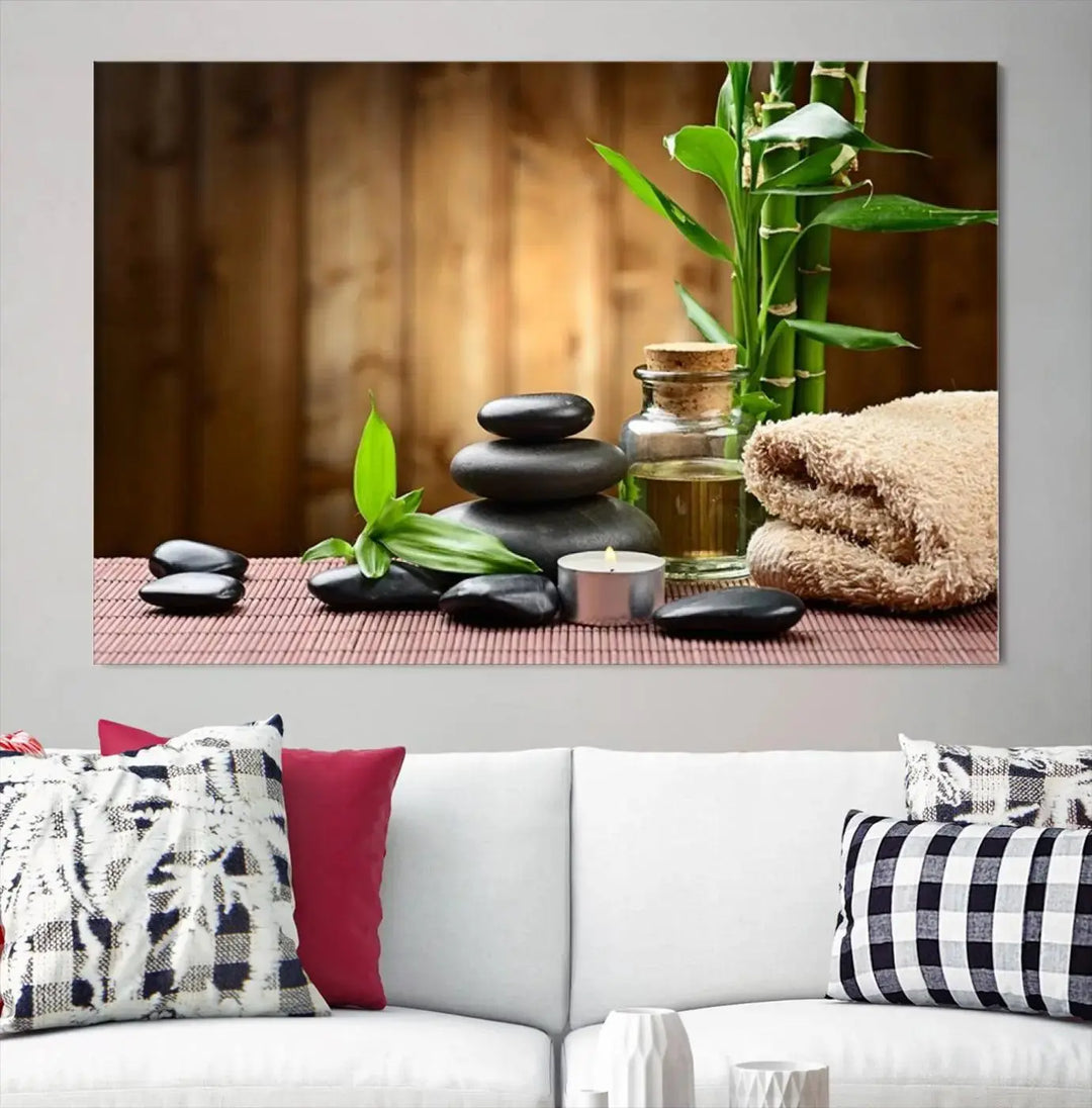 The Zen Serenity Triptych Canvas Art adorns the wall, featuring a pink lotus flower, balancing stones, towels, and bamboo.