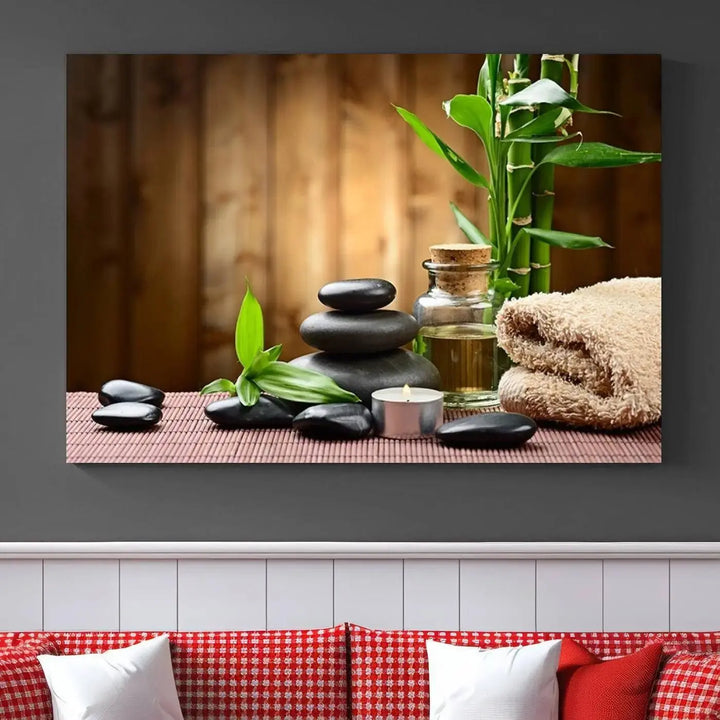 The Zen Serenity Triptych Canvas Art adorns the wall, featuring a pink lotus flower, balancing stones, towels, and bamboo.