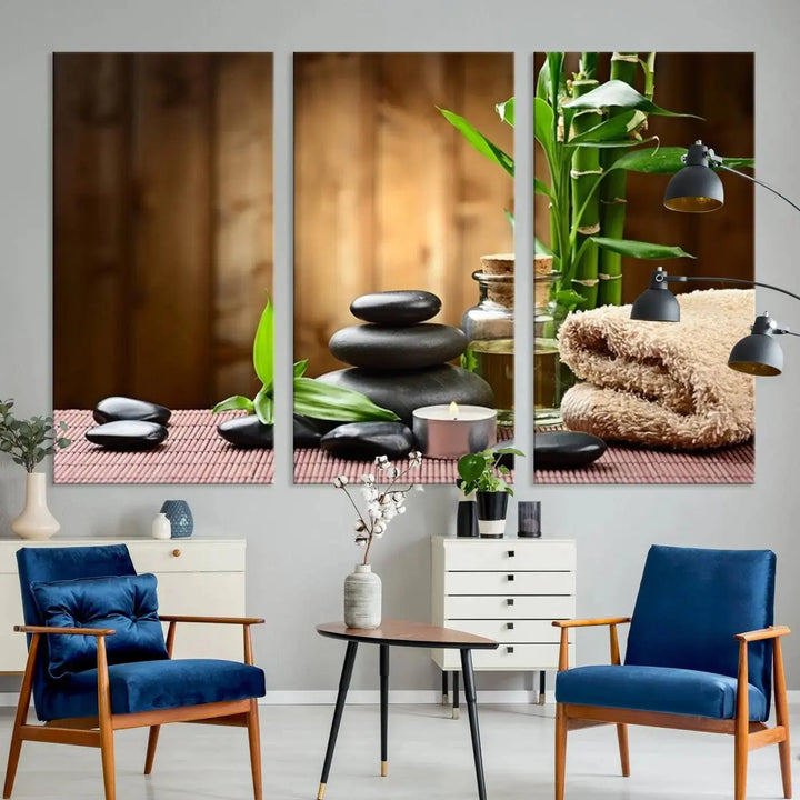 The Zen Serenity Triptych Canvas Art adorns the wall, featuring a pink lotus flower, balancing stones, towels, and bamboo.