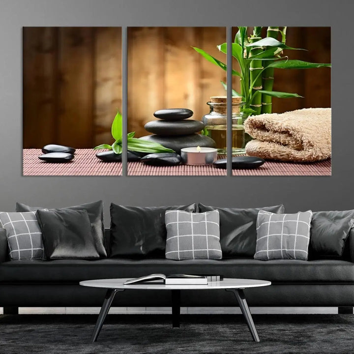 The Zen Serenity Triptych Canvas Art adorns the wall, featuring a pink lotus flower, balancing stones, towels, and bamboo.