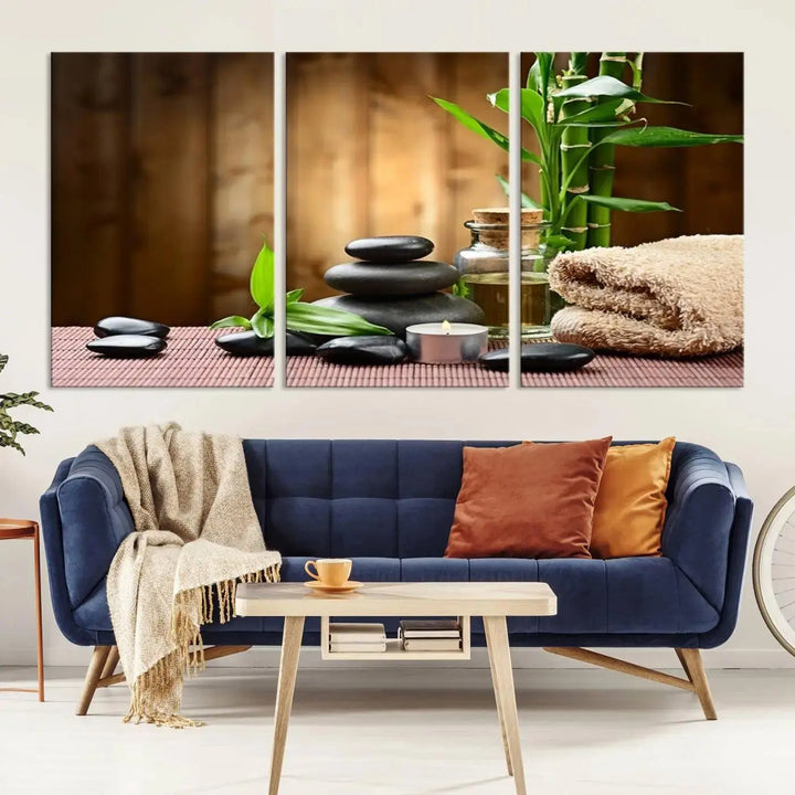 The Zen Serenity Triptych Canvas Art adorns the wall, featuring a pink lotus flower, balancing stones, towels, and bamboo.