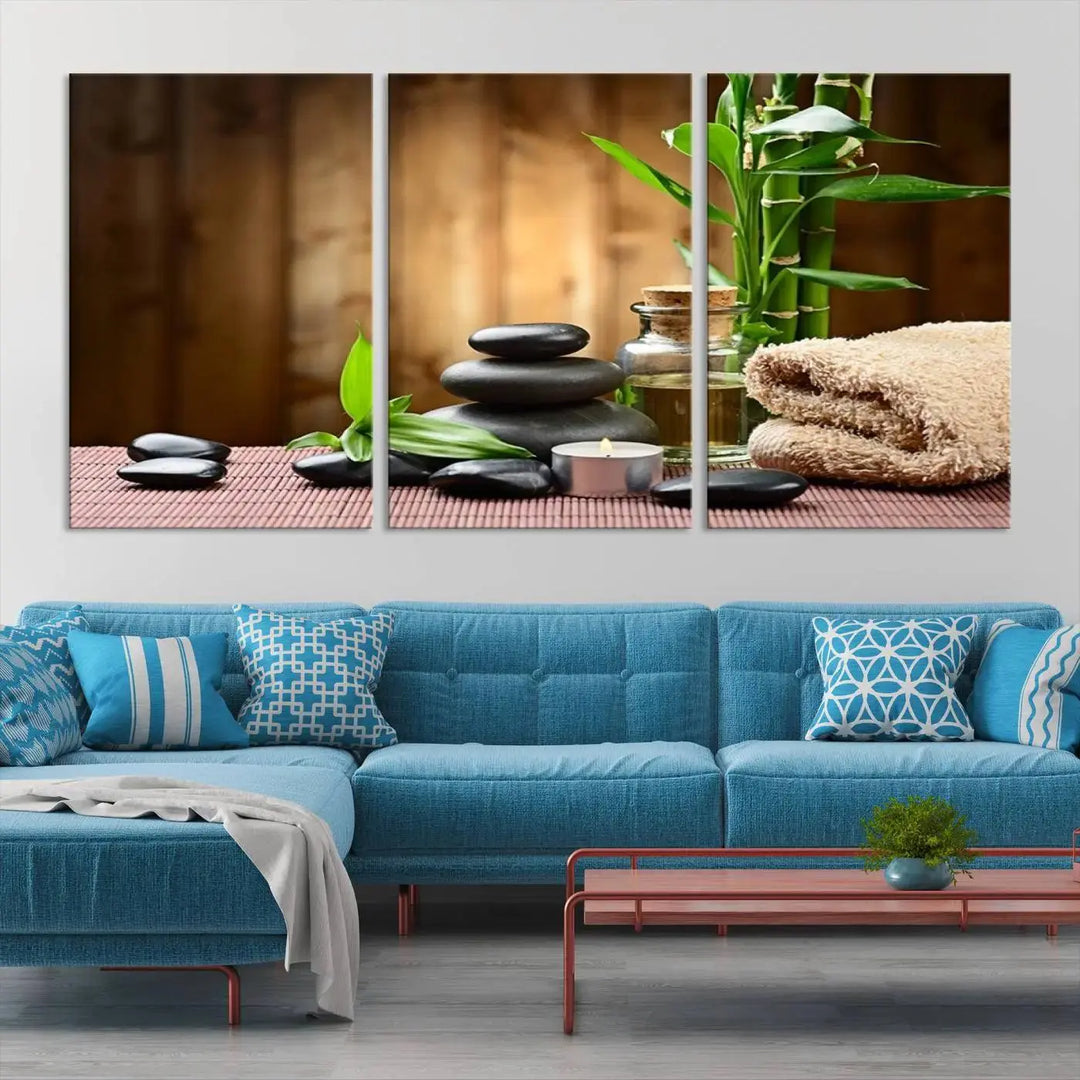 The Zen Serenity Triptych Canvas Art adorns the wall, featuring a pink lotus flower, balancing stones, towels, and bamboo.