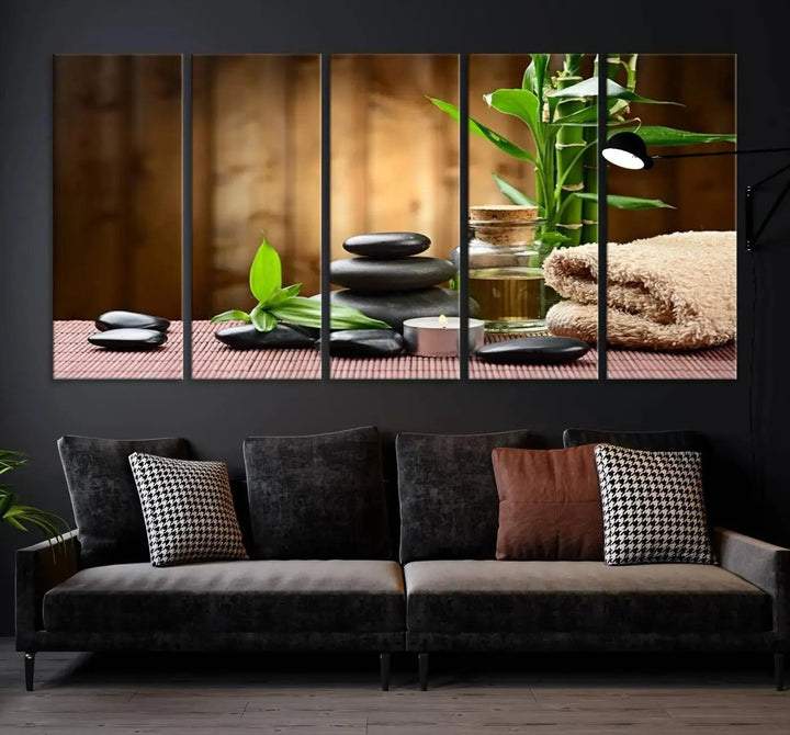 The Zen Serenity Triptych Canvas Art adorns the wall, featuring a pink lotus flower, balancing stones, towels, and bamboo.