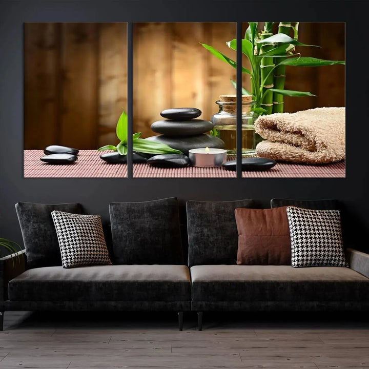 The Zen Serenity Triptych Canvas Art adorns the wall, featuring a pink lotus flower, balancing stones, towels, and bamboo.