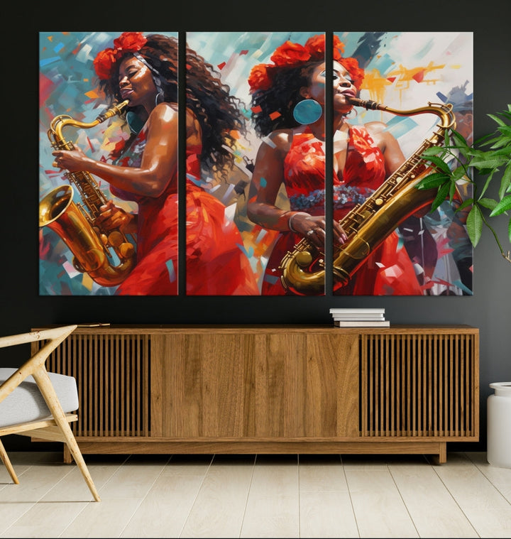 The "Abstract African American Saxophonist Musician Women Wall Art" features a three-panel design depicting two women in red dresses playing saxophones. This premium canvas boasts a gallery-quality finish that enhances any living space with its vibrant charm.