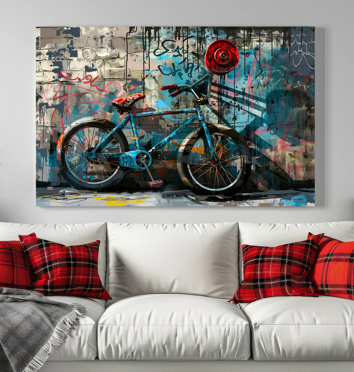 A modern living room features a triptych wall art of an abstract bicycle, designed in a graffiti style on a brick wall. This piece is expertly crafted on the Abstract Bicycle Wall Art Canvas Print, offering a premium canvas that ensures a gallery-quality finish.